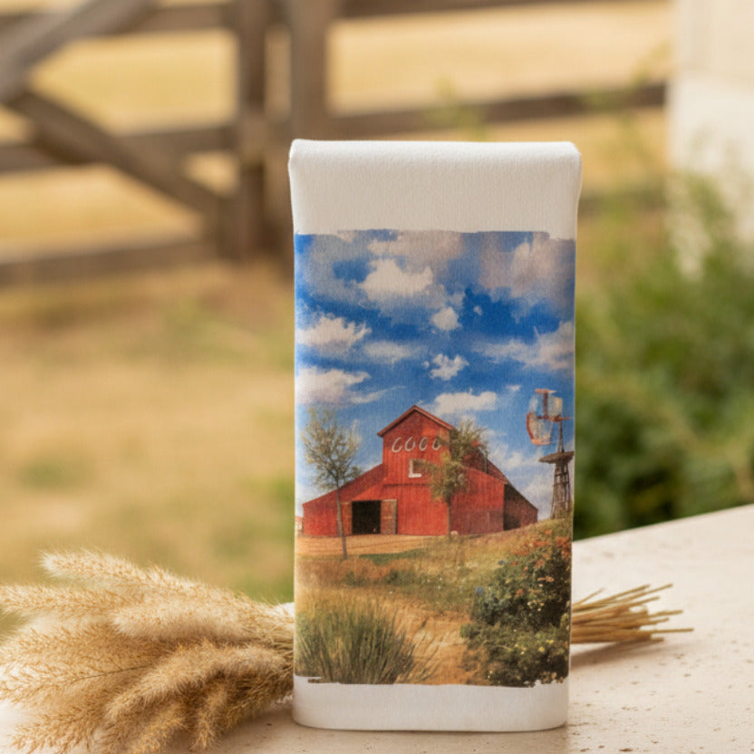 Printed paper with a red barn and blue sky design on a gray wall.