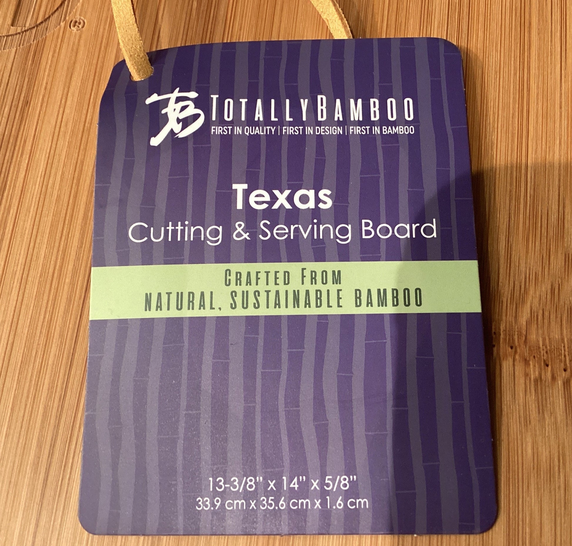 Totally Bamboo Texas cutting and serving board packaging on a wooden surface