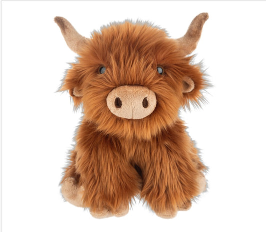 Plush toy Highland cow on a white background