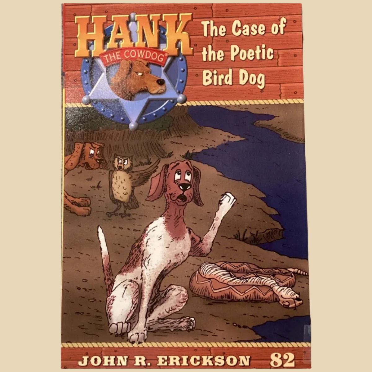 Book titled 'Hank the Cowdog: The Case of the Poetic Bird Dog' by John R. Erickson on a gray surface.