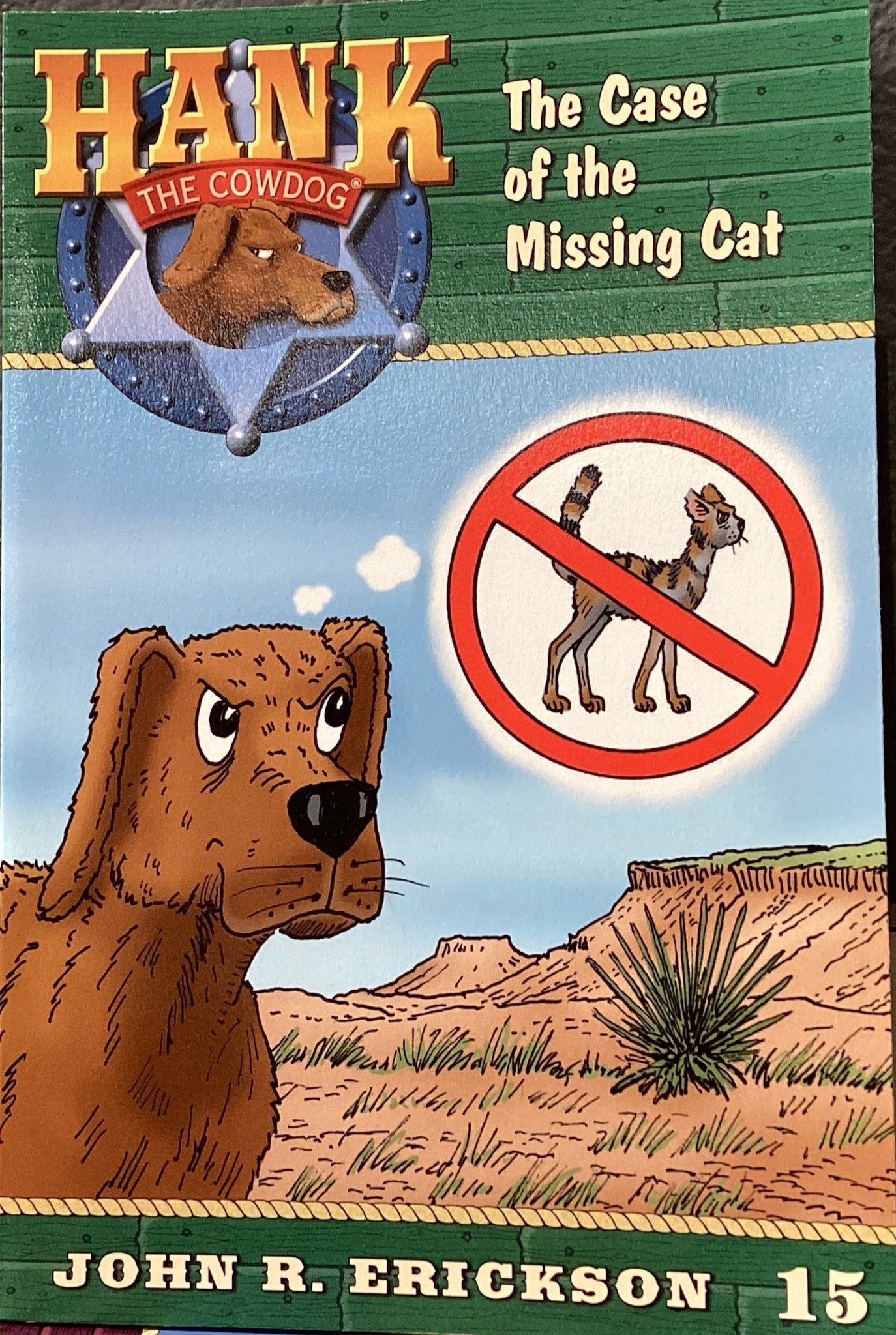 Book titled 'Hank the Cowdog: The Case of the Missing Cat' by John R. Erickson on a shelf.