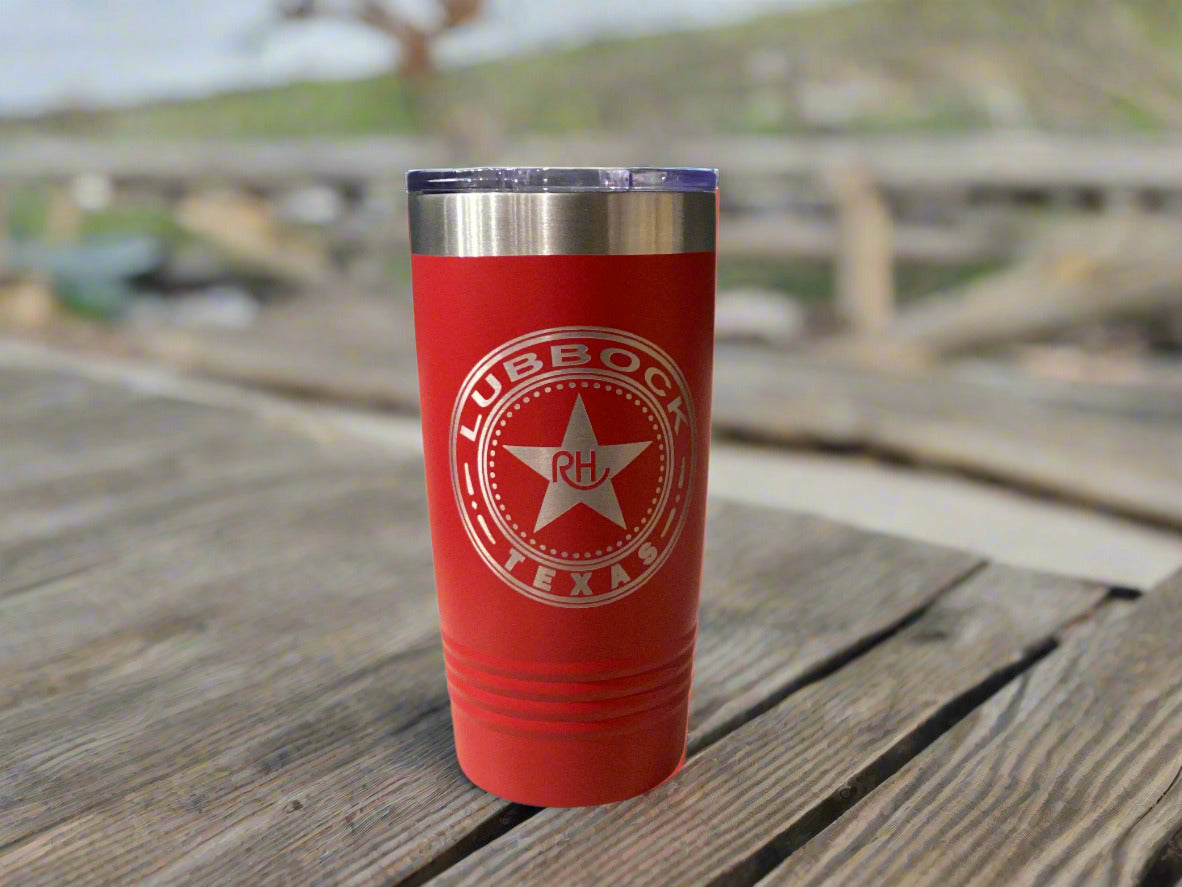 Red tumbler with Lubbock, Texas logo on a gray wall background