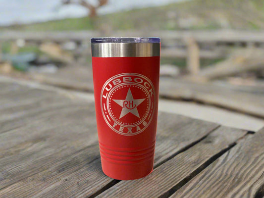 Red tumbler with Lubbock, Texas logo on a gray wall background