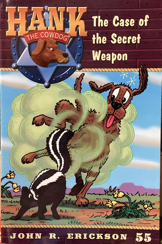 Book titled 'Hank the Cowdog: The Case of the Secret Weapon' by John R. Erickson on a surface.