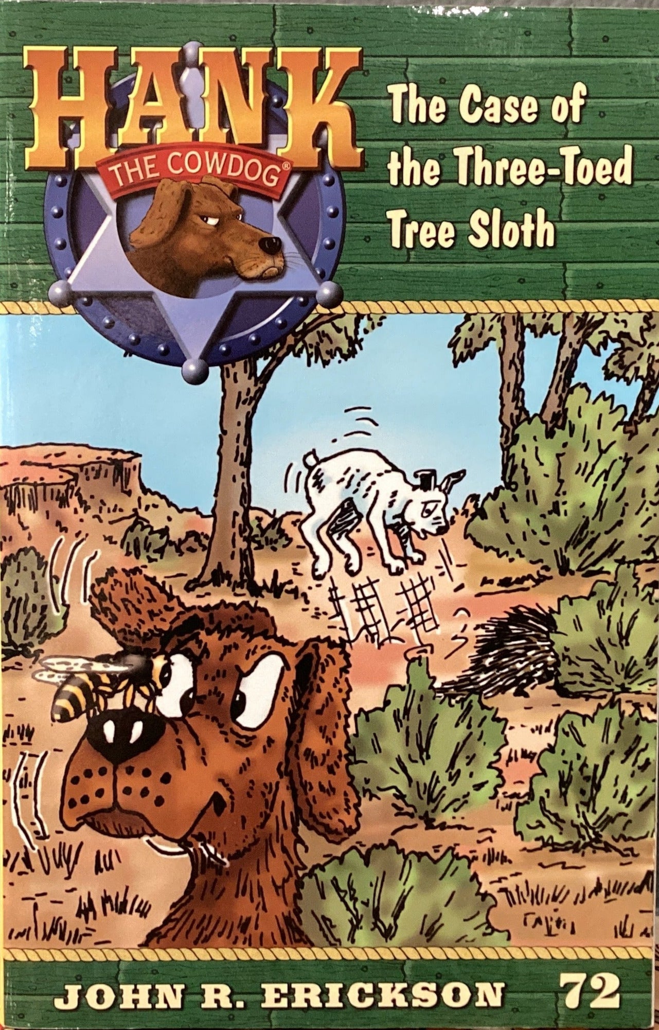 Book titled 'Hank the Condoog: The Case of the Three-Toed Tree Sloth' by John R. Erickson on a gray surface.