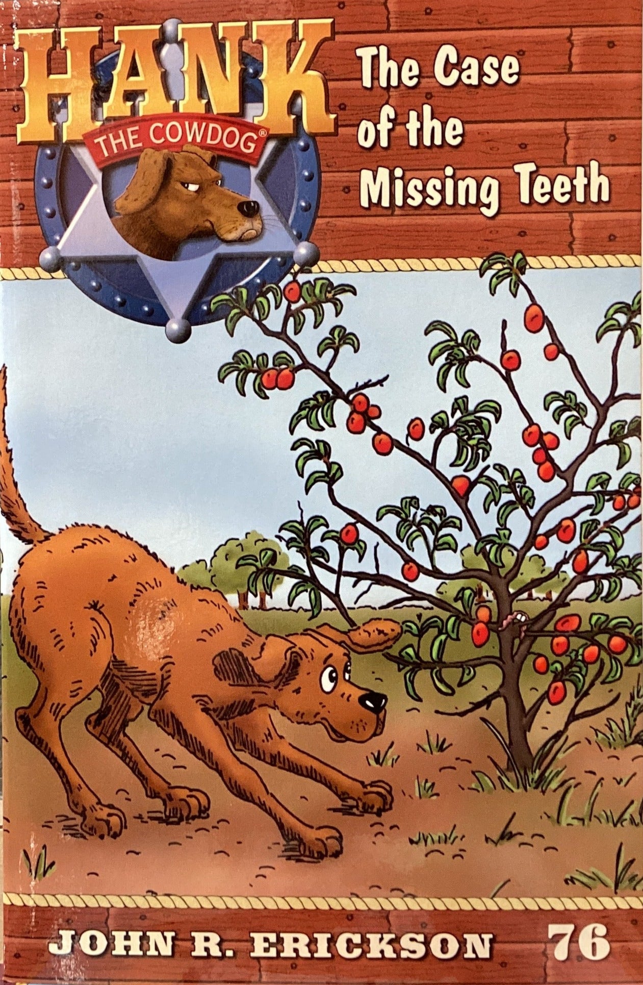 Book titled 'Hank the Cowdog: The Case of the Missing Teeth' by John R. Erickson on a gray surface.