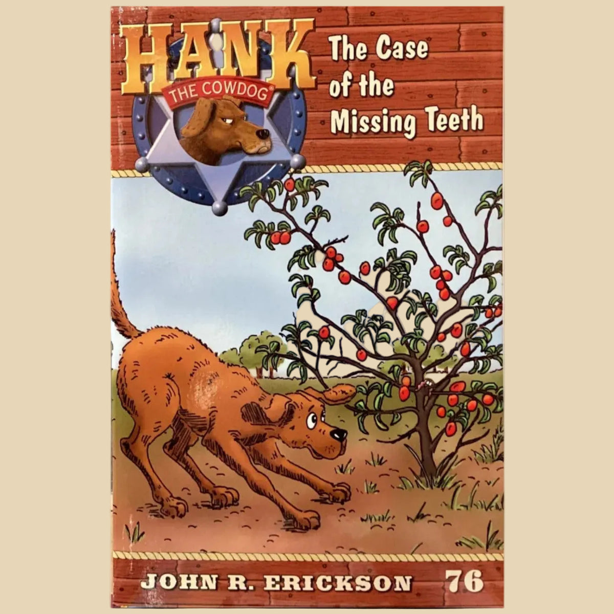 Book titled 'Hank the Cowdog: The Case of the Missing Teeth' by John R. Erickson on a gray surface.