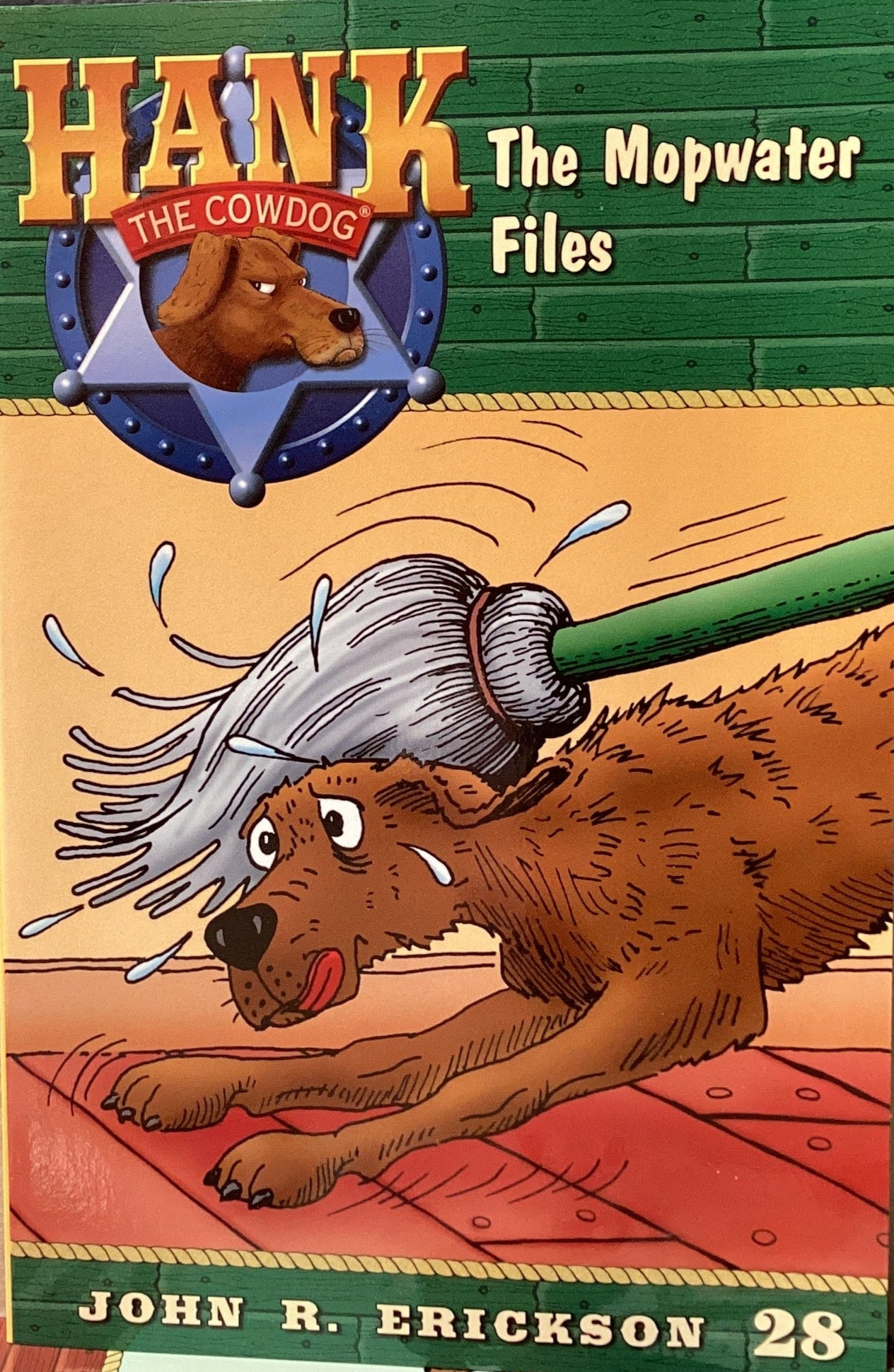 Book titled 'Hank the Cowdog: The Mopwater Files' by John R. Erickson on a gray surface.