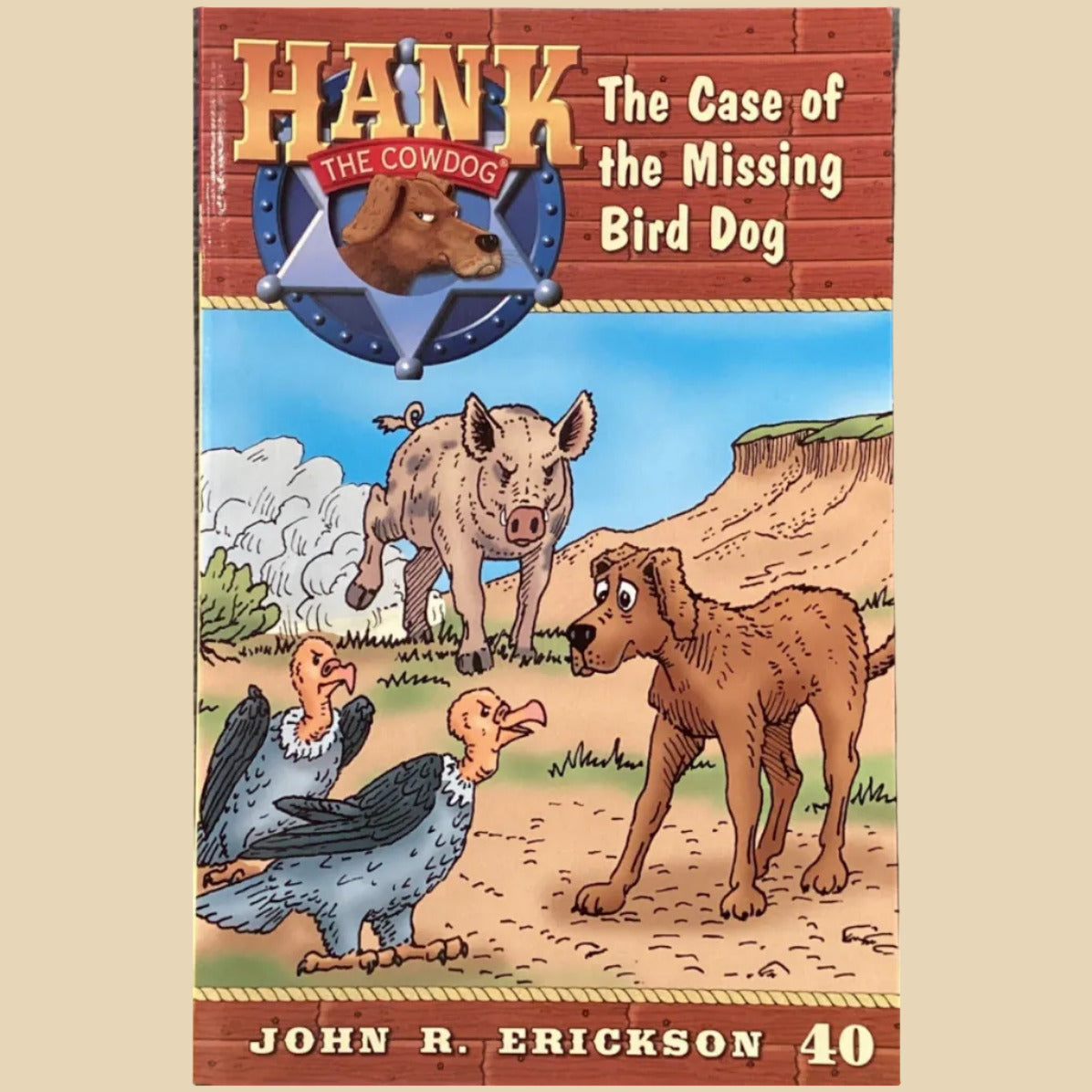 Book titled 'Hank the Cowdog: The Case of the Missing Bird Dog' by John R. Erickson on a gray surface.