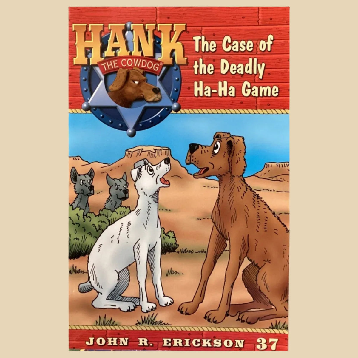 Book titled 'Hank the Cowdog: The Case of the Deadly Ha-Ha Game' by John R. Erickson on a surface with a gray wall background.