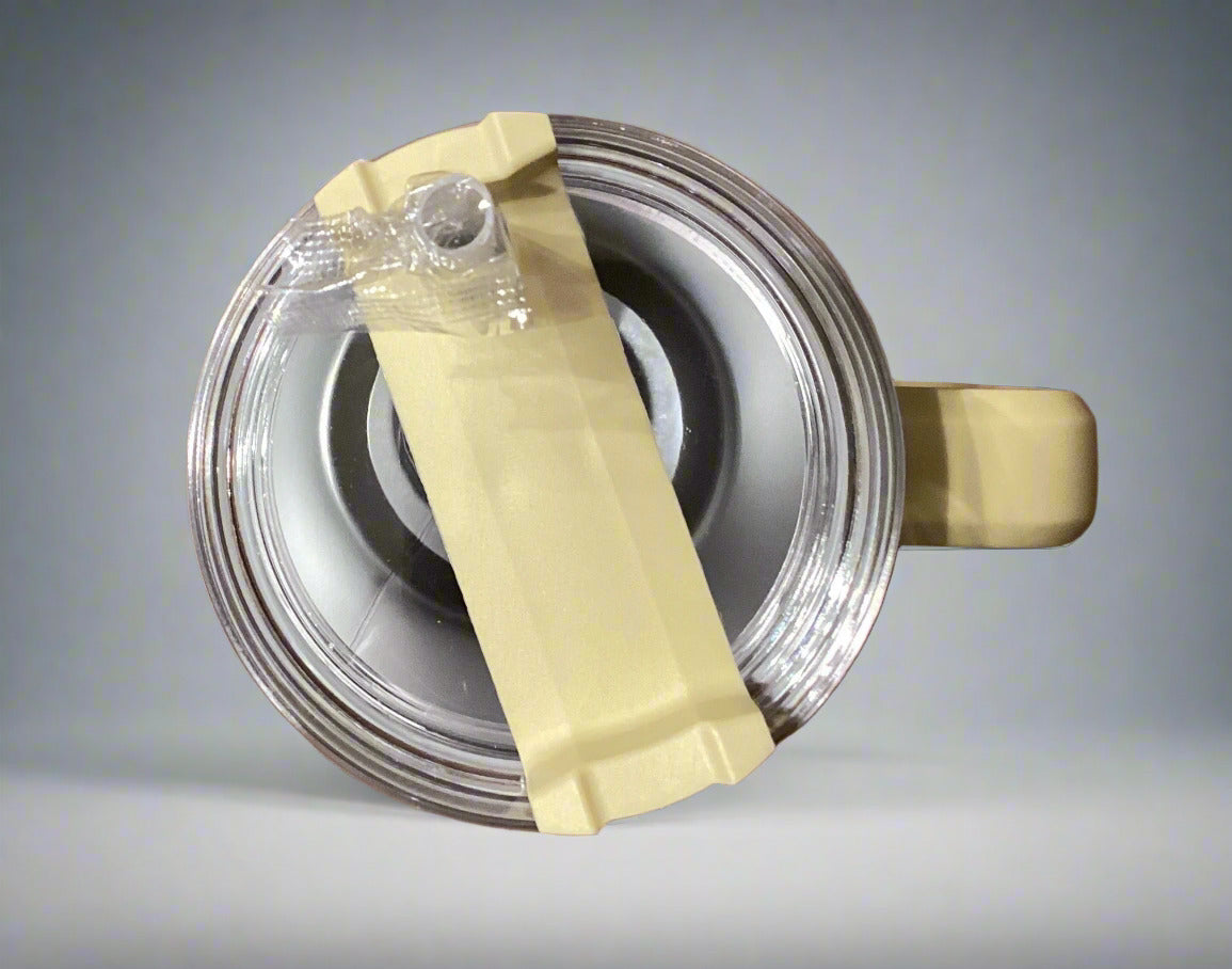 Can of spray paint with a yellow stick on a wooden surface