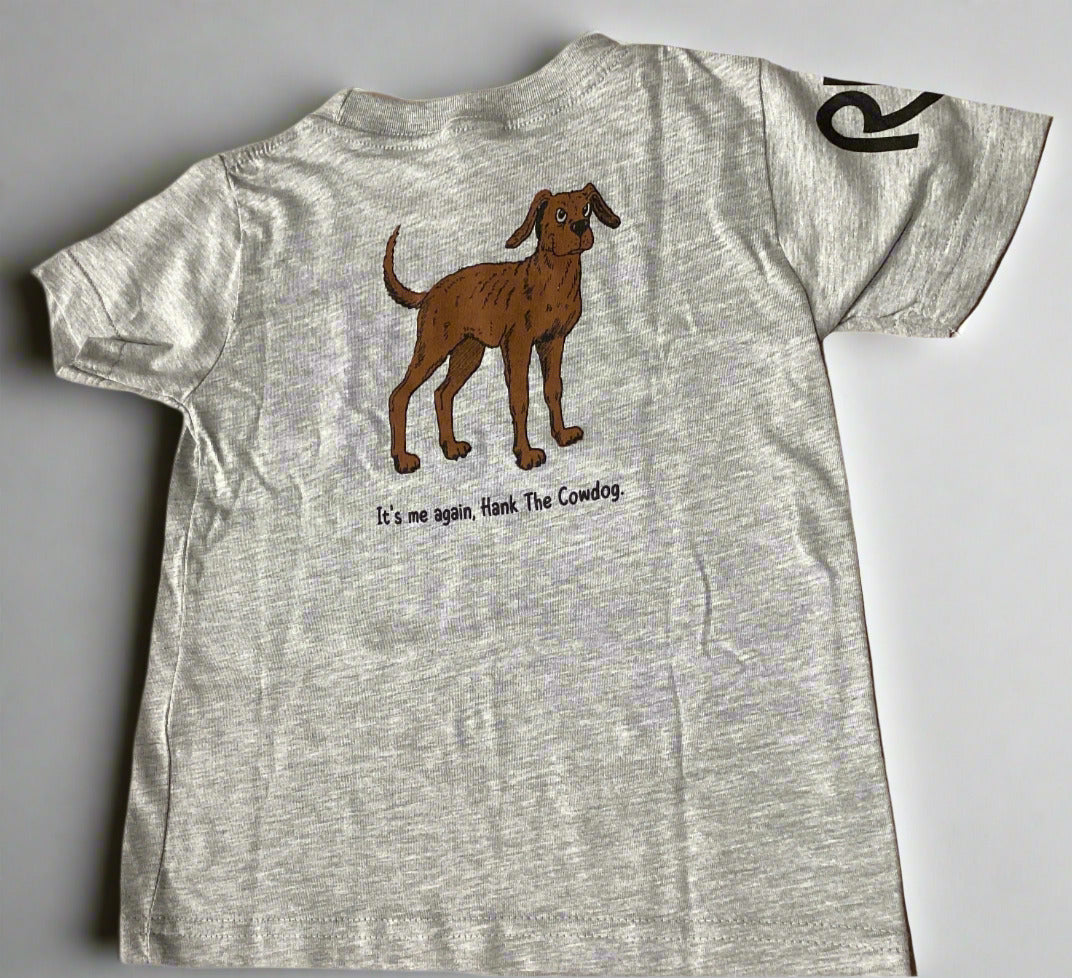 Gray t-shirt with a brown dog graphic and text on a beige surface