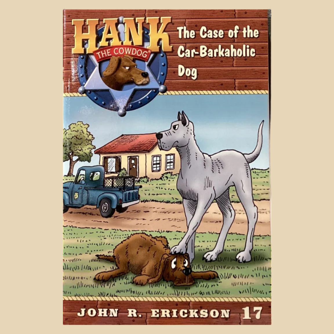 Book titled 'Hank: The Case of the Car-Barkhole Dog' by John R. Erickson on a shelf.
