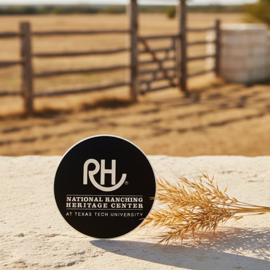 Round black sticker with 'RH' logo and text on a textured gray surface.