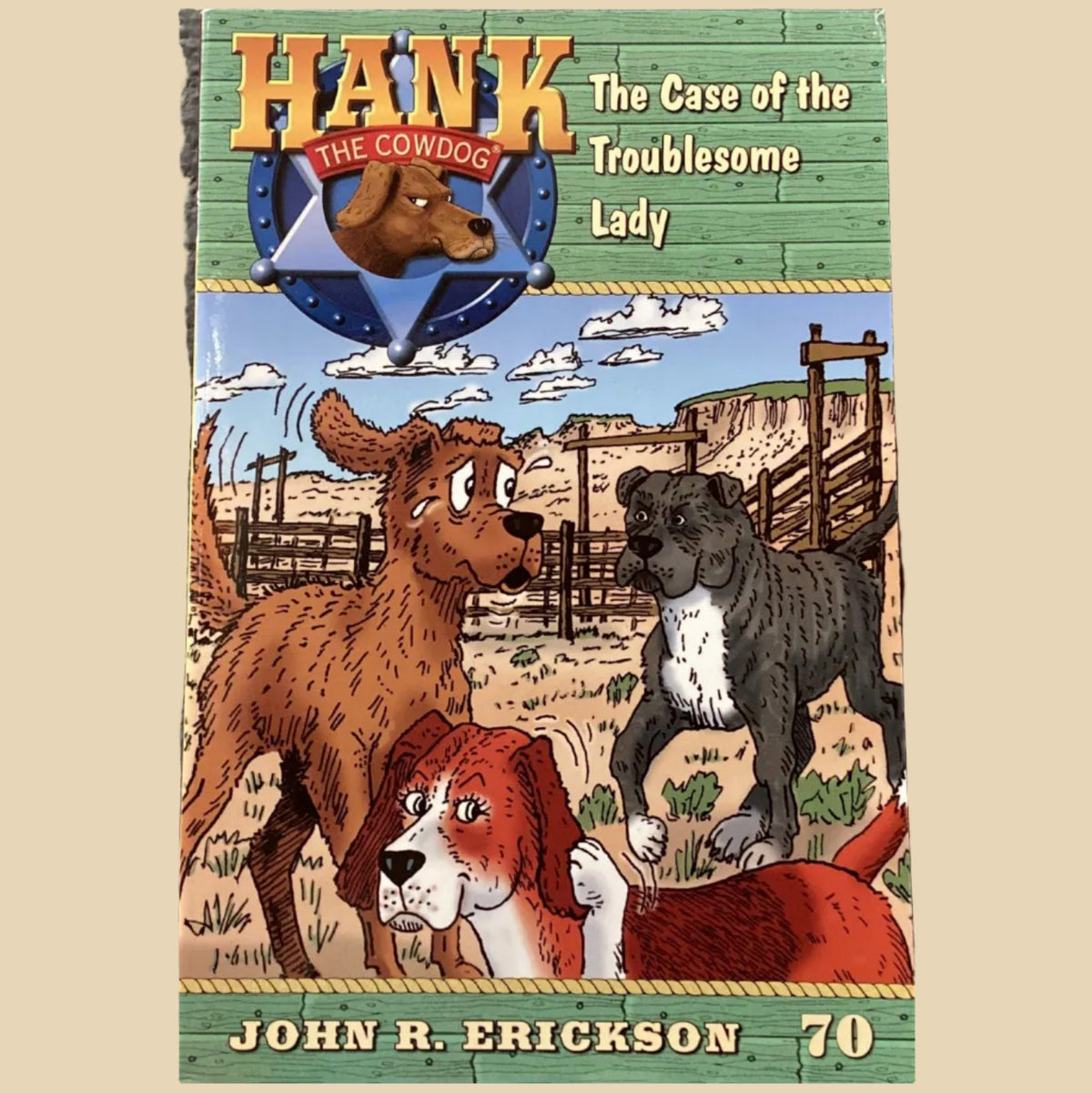 Book cover of 'Hank the Cowdog: The Case of the Troublesome Lady' by John R. Erickson on a dark surface.
