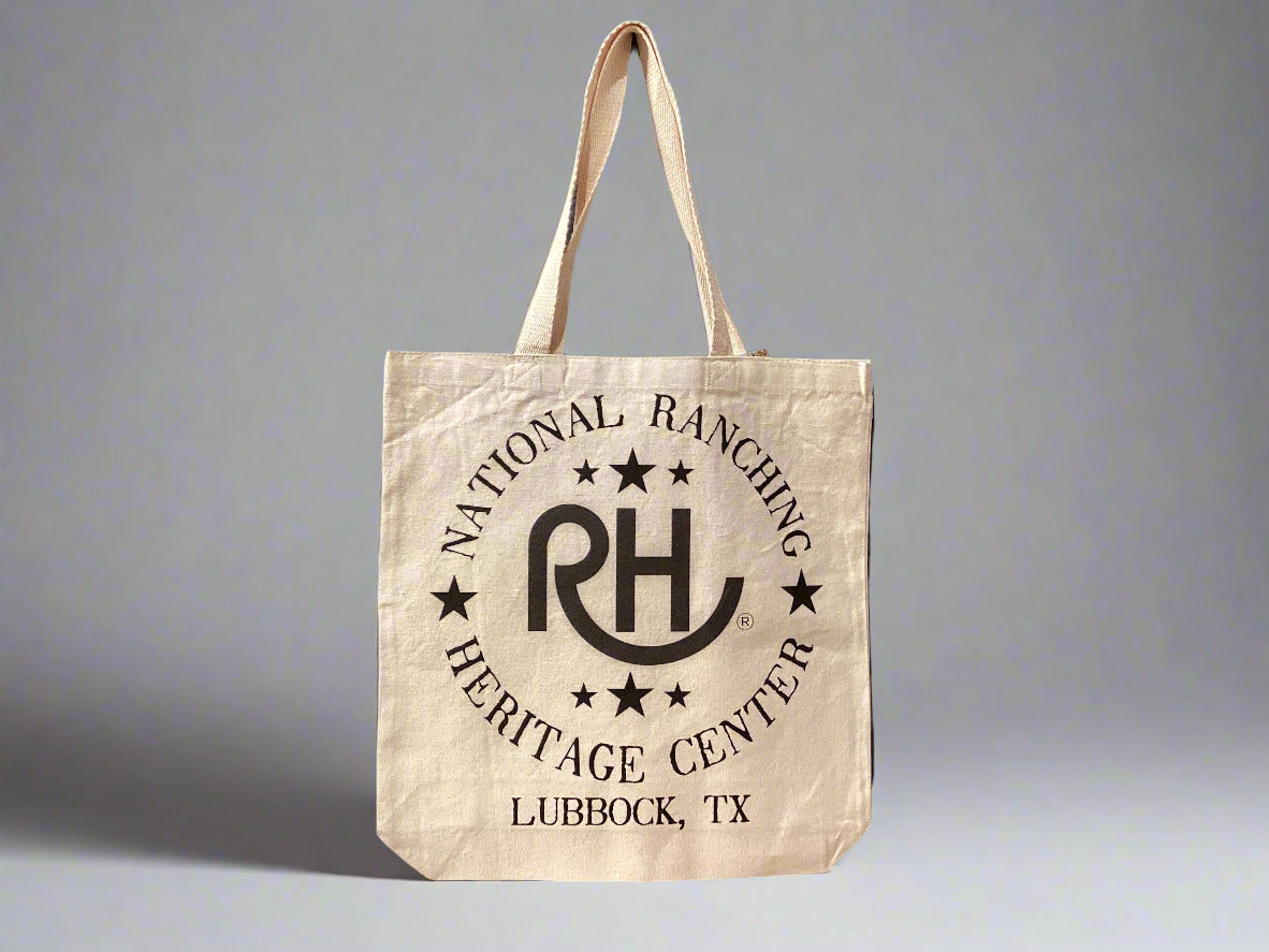 Beige tote bag with 'National Ranching Heritage Center' logo on a gray wall.