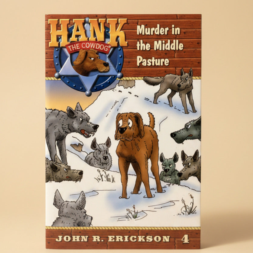 Book titled 'Hank the Cowdog: Murder in the Middle Pasture' by John R. Erickson on a gray surface.