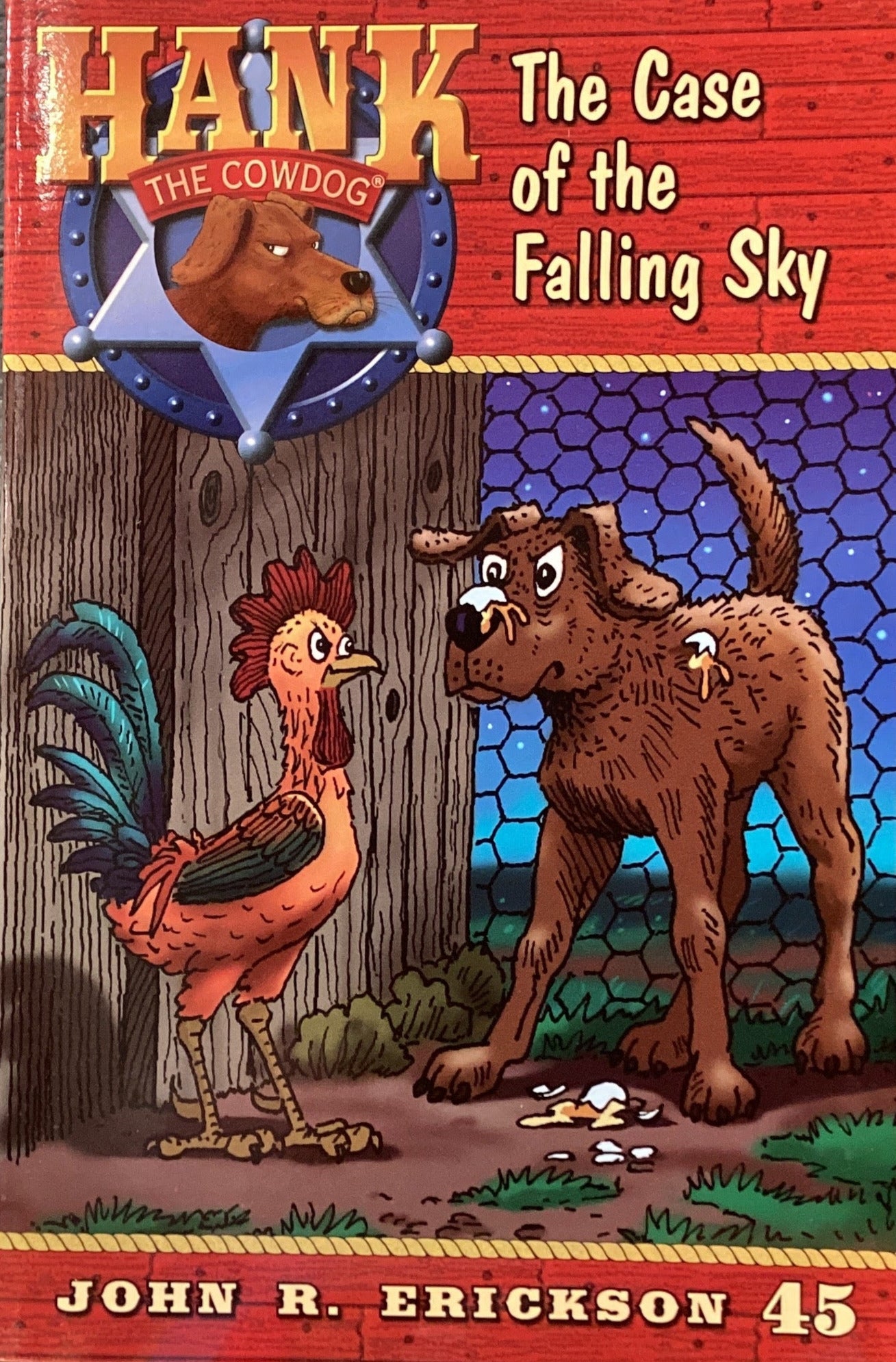 Book titled 'Hank the Cowdog: The Case of the Falling Sky' by John R. Erickson on a surface with a gray wall background.