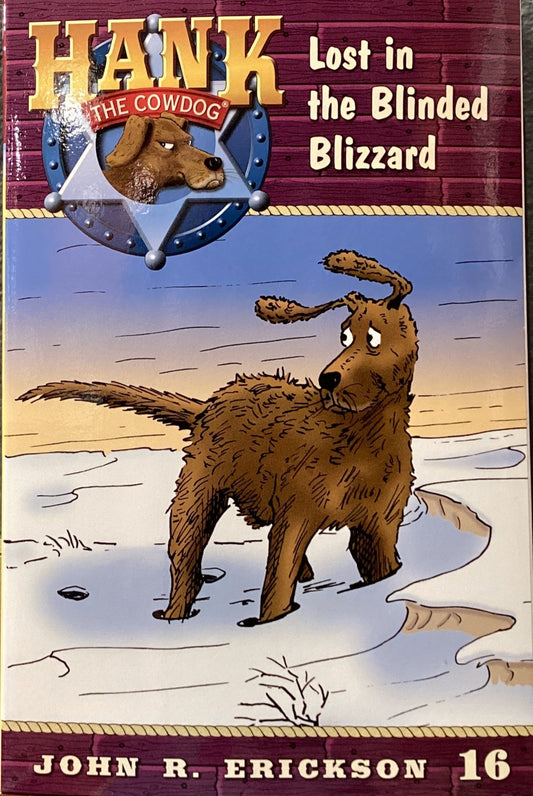 Book titled 'Hank the Cowdog: Lost in the Blinded Blizzard' by John R. Erickson on a gray surface.