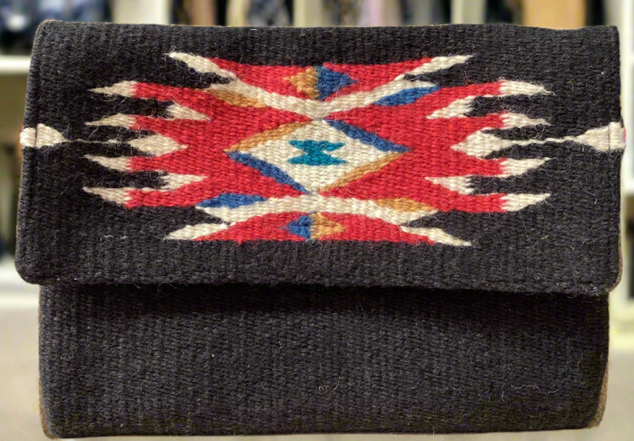 Black clutch with a colorful geometric pattern on a gray surface