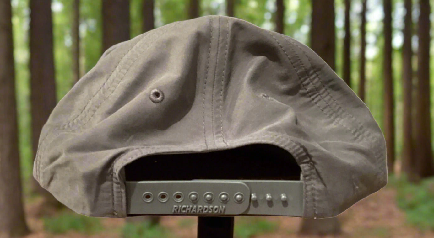 Gray cap with 'Richardson' branding on a wooden surface