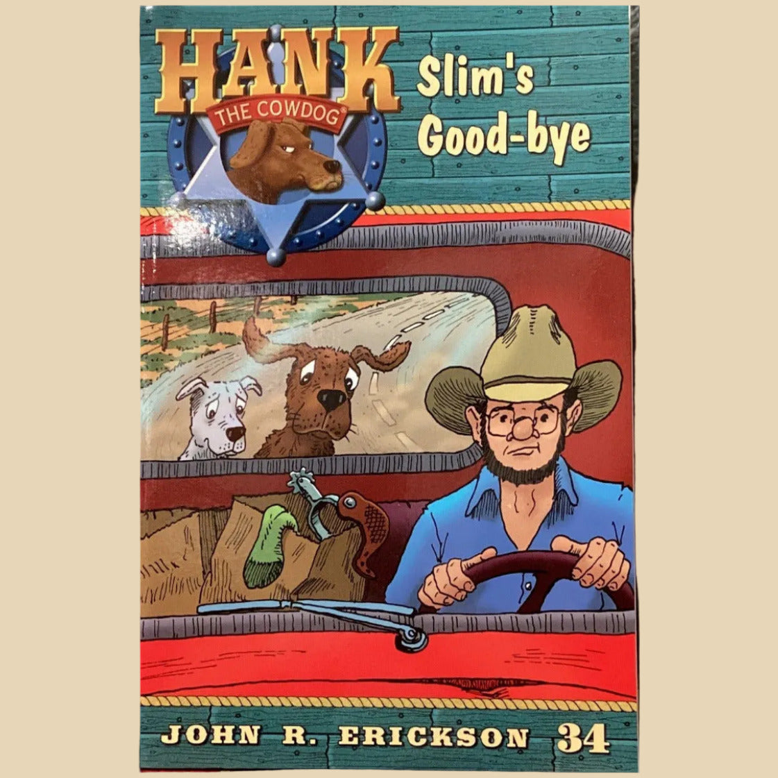 Book titled 'Hank Slim's Good-bye' by John R. Erickson on a shelf against a gray wall.