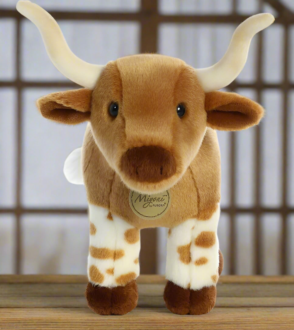 Plush toy longhorn cow on a white background