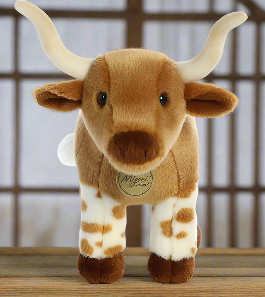 Plush toy longhorn cow on a white background