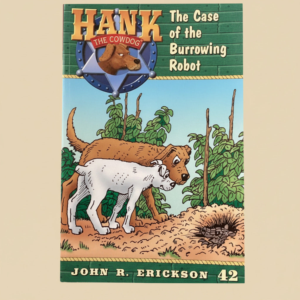 Children's book titled 'Hank the Cowdog: The Case of the Burrowing Robot' by John R. Erickson on a gray surface.