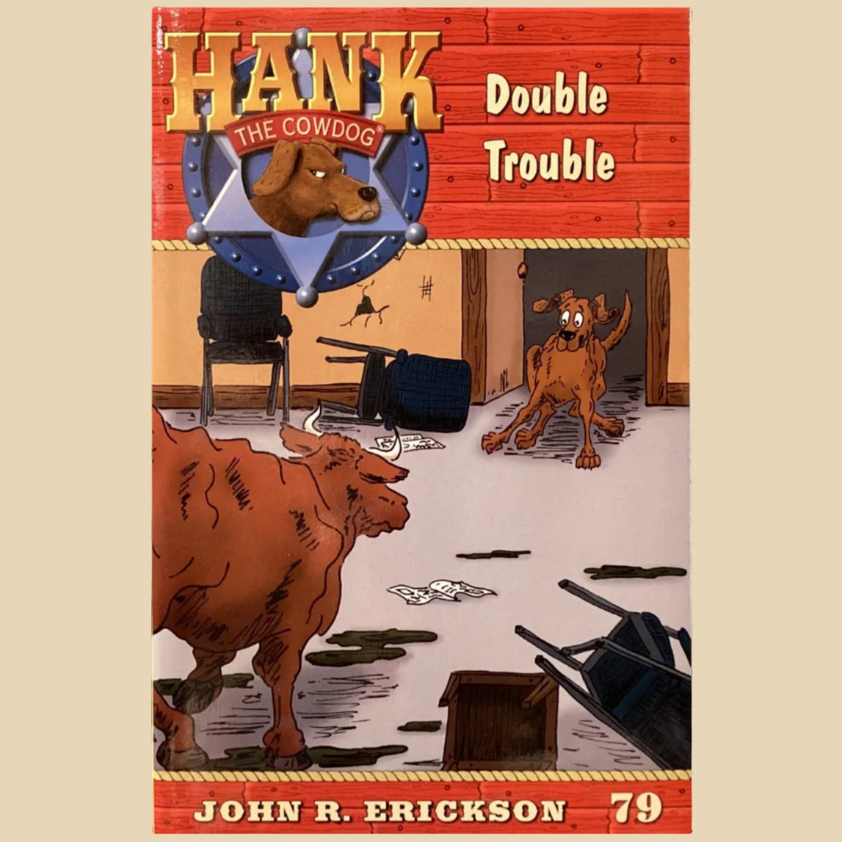 Book titled 'Hank the Cowdog: Double Trouble' by John R. Erickson on a gray floor.