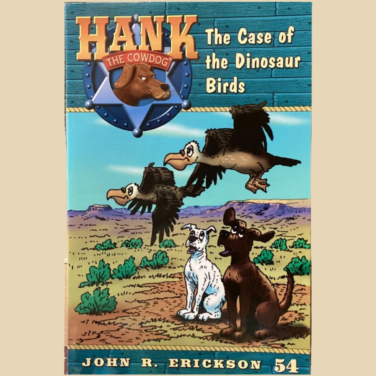 Book titled 'Hank the Cowdog: The Case of the Dinosaur Birds' by John R. Erickson on a shelf.