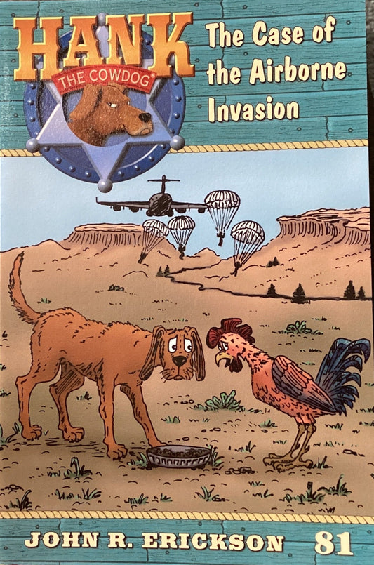 Book titled 'Hank the Cowdog: The Case of the Airborne Invasion' by John R. Erickson on a gray surface.
