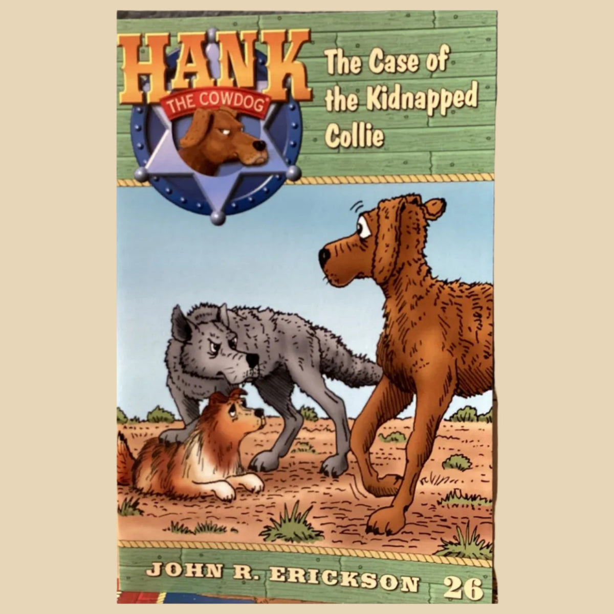 Book titled 'Hank the Cowdog: The Case of the Kidnapped Collie' by John R. Erickson on a shelf.