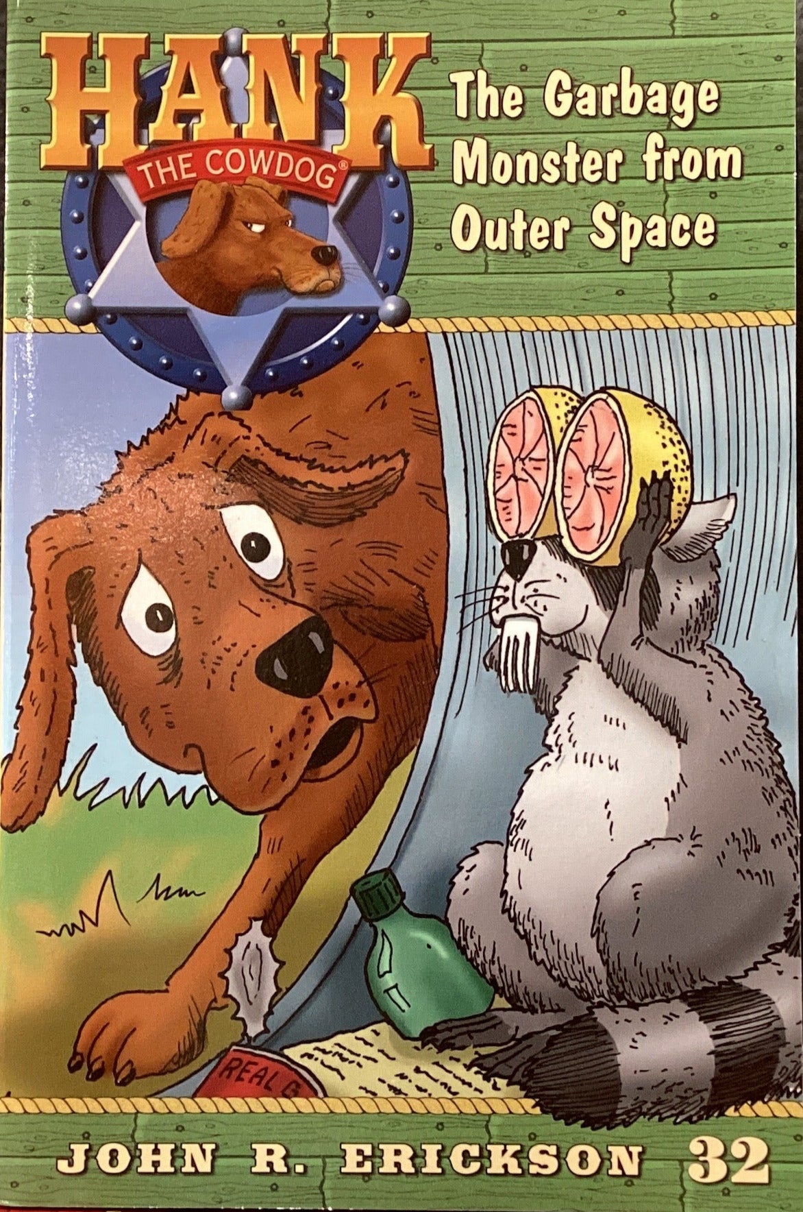 Children's book titled 'Hank the Garbage Monster from Outer Space' by John R. Erickson on a shelf.