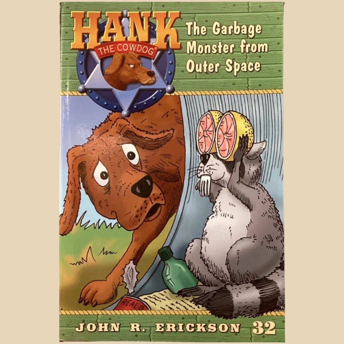 Children's book titled 'Hank the Garbage Monster from Outer Space' by John R. Erickson on a shelf.