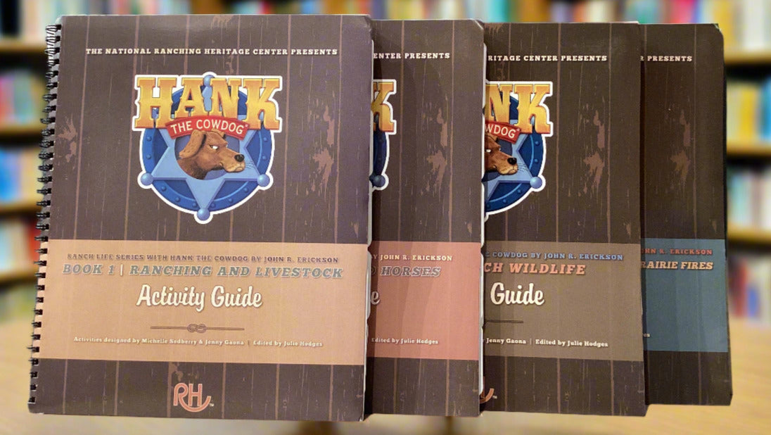 Set of four 'Hank the Cowdog' activity guides on a surface with a gray wall background.