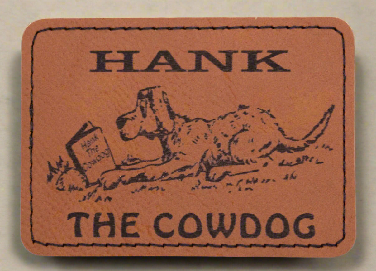 Leather patch with illustration of a dog and text 'Hank the Cowdog' on a brown background