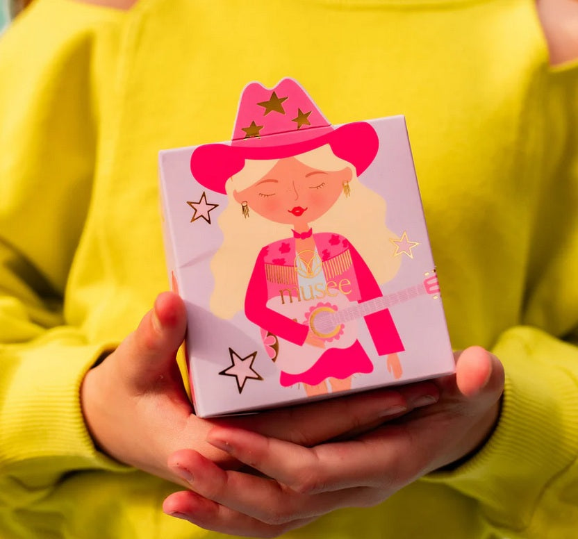 Person holding a pink and purple box with a cartoon character wearing a cowboy hat.