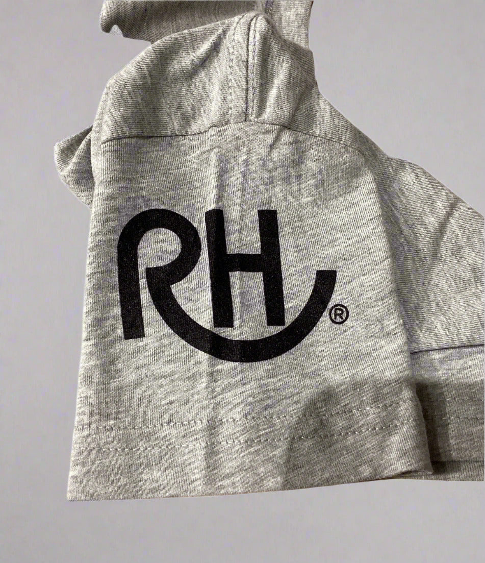 Gray t-shirt with a black logo on a beige surface