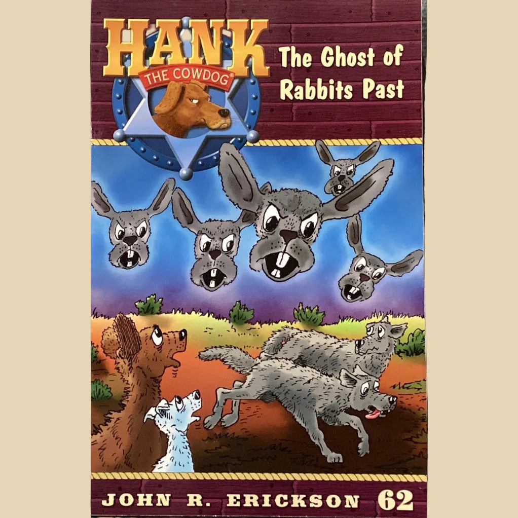 Book titled 'Hank the Cowdog: The Ghost of Rabbits Past' by John R. Erickson on a shelf against a gray wall.