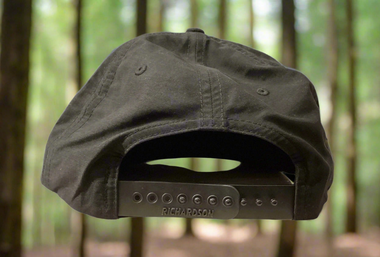 Black cap with 'Richardson' branding on a surface