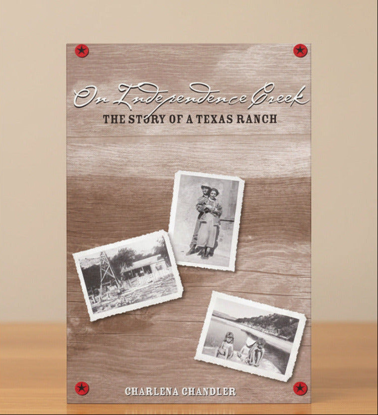 A book cover titled "On Independence Creek: The Story of a Texas Ranch" by Charlena Chandler, shown standing upright on a wooden surface against a beige background. The cover has a rustic wood texture with three vintage-style black-and-white photos and red corner accents.