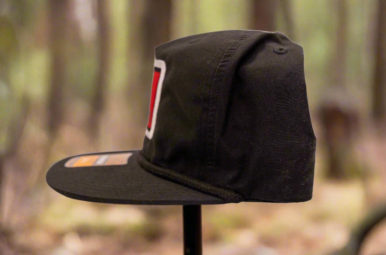 Black cap with a logo on a light gray background