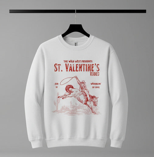 White sweatshirt with red graphic and text about St. Valentine's Rodeo on a white background