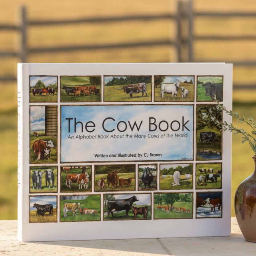 Book titled 'The Cow Book' with images of cows on a white background