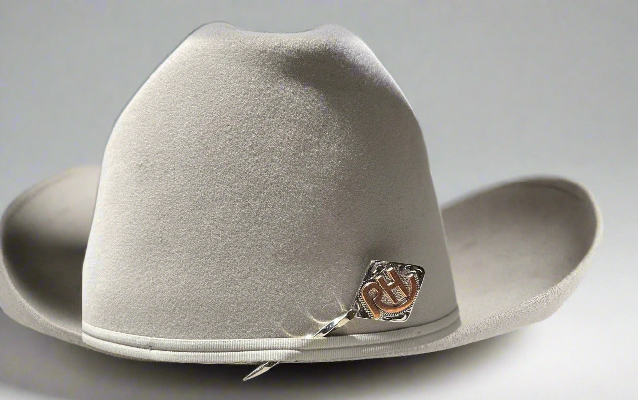 White cowboy hat with a brand logo on a white surface