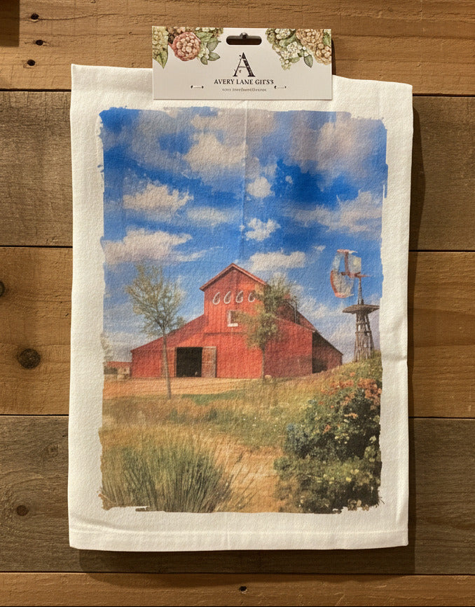 Printed paper with a red barn and blue sky design on a gray wall.