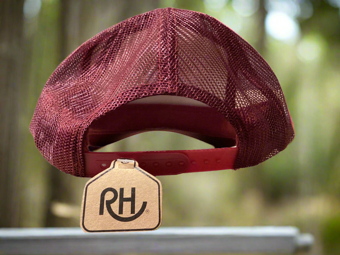 Maroon mesh cap with a brand tag on a gray surface