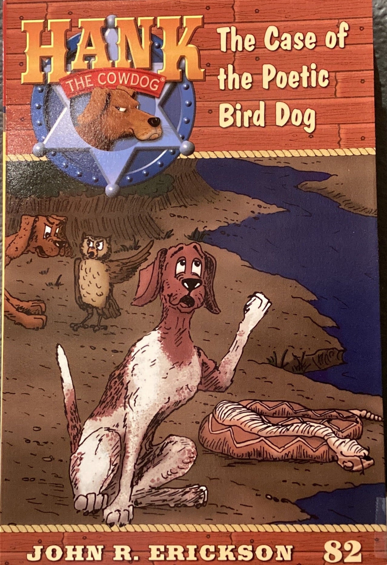 Book titled 'Hank the Cowdog: The Case of the Poetic Bird Dog' by John R. Erickson on a gray surface.