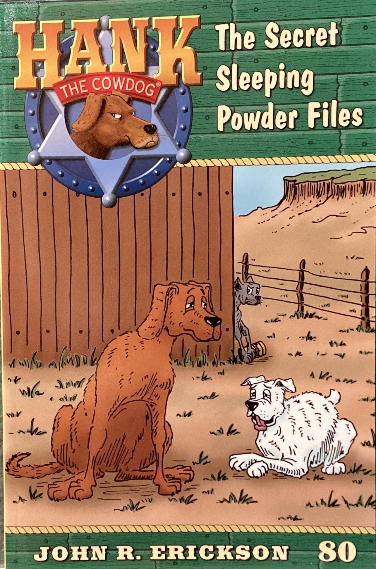 Book cover of 'Hank the Cowdog: The Secret Sleeping Powder Files' by John R. Erickson on a gray surface.